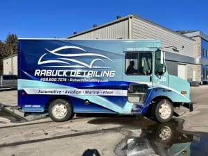 Detailing truck with fleet vehicle wrap graphic of a car outline and blue colors