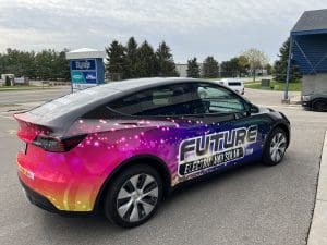 Future electric and solar company Tesla Model Y with colorful Fleet Graphics Vehicle wrap designed by Madison Graphics Company