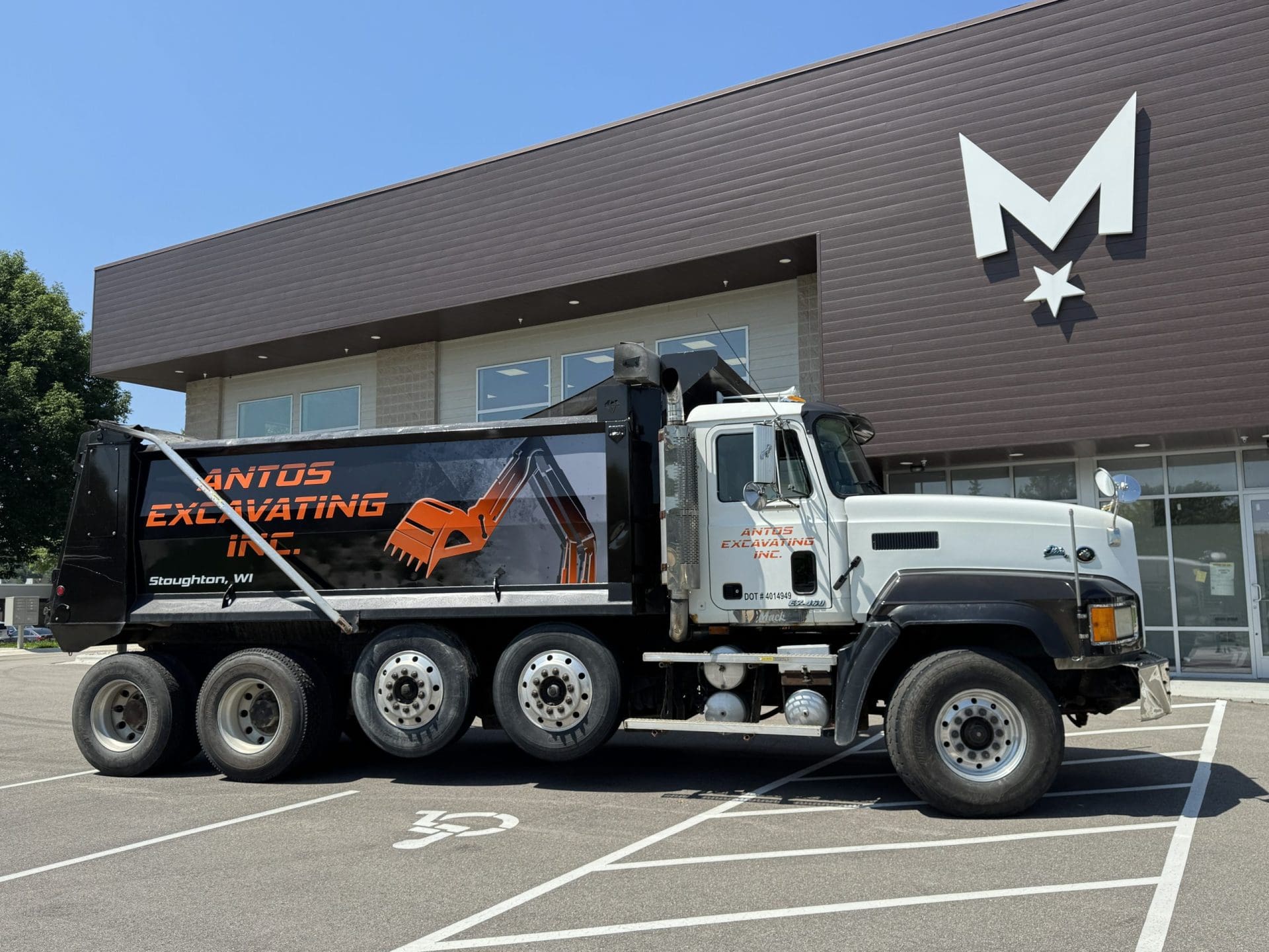 Partial Wrap - Antos Excavating Back of a commercial van with a business fleet vehicle wrap promoting a roofing business